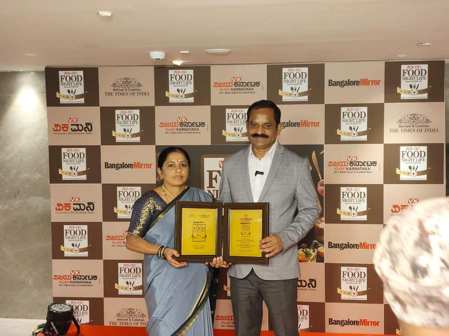 Owners holding award plaques at VK BM Food Night Life Awards