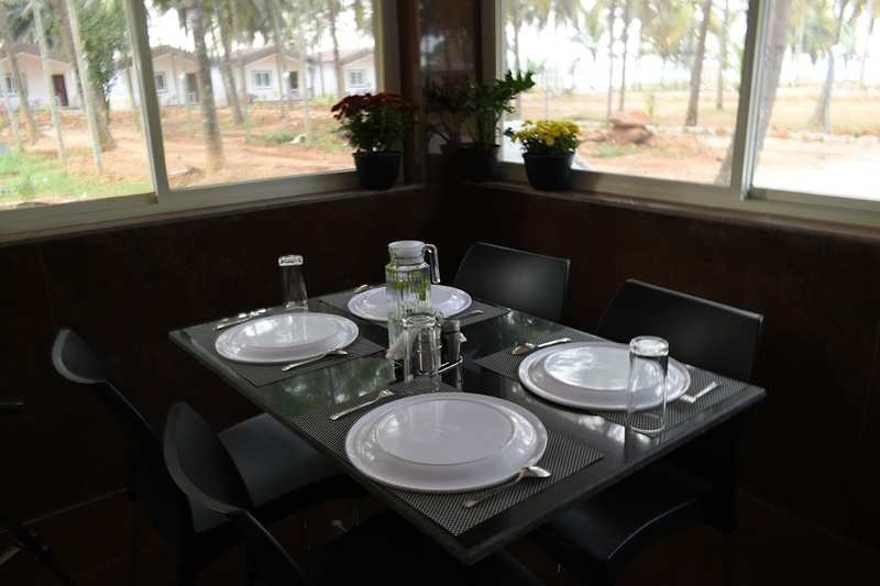 Restaurant table setting for four with garden window view
