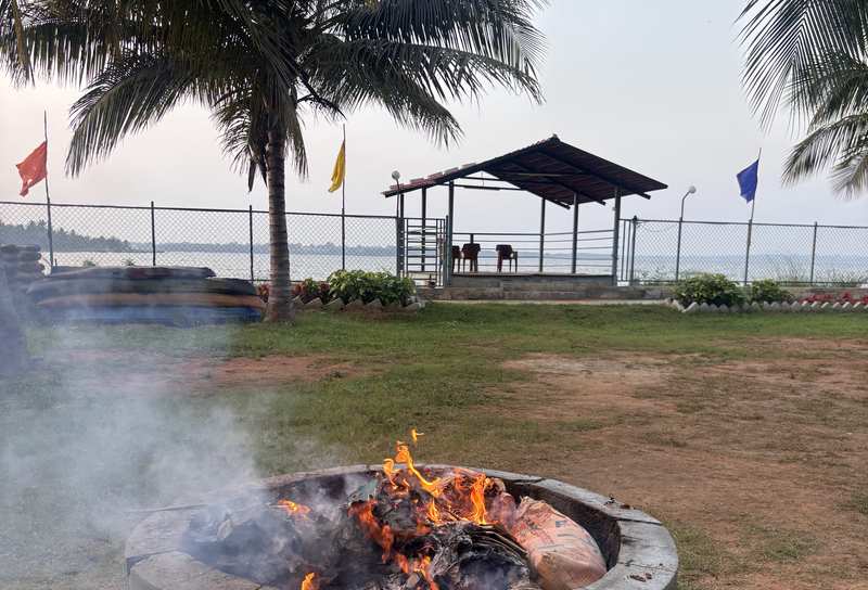 Bonfire close-up at resort with lake in background