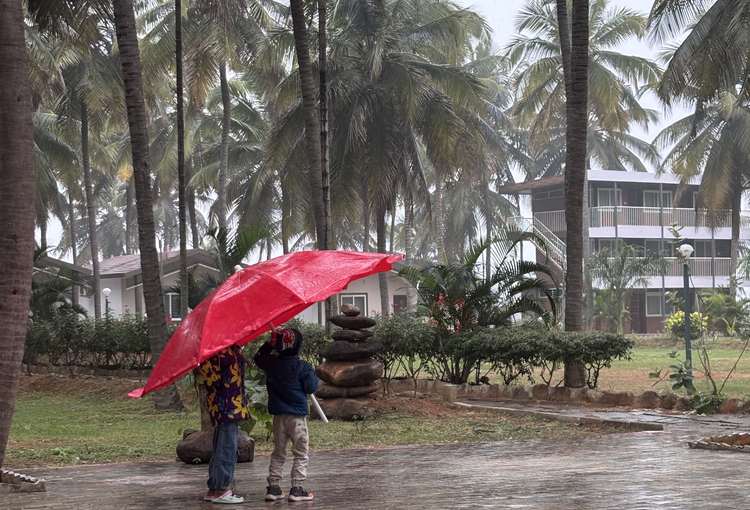 Romantic couple with red umbrella at resort